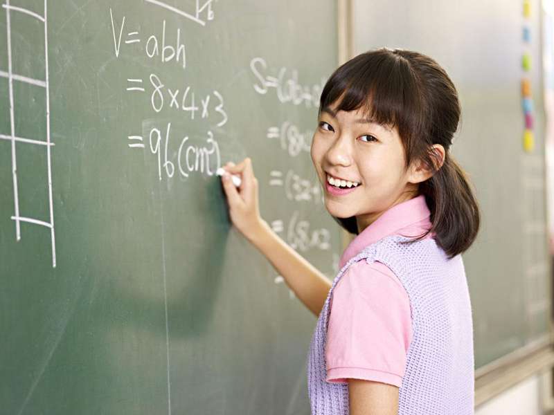 Asian student at chalkboard