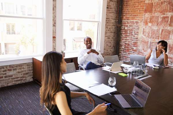 Employees sitting around conference table